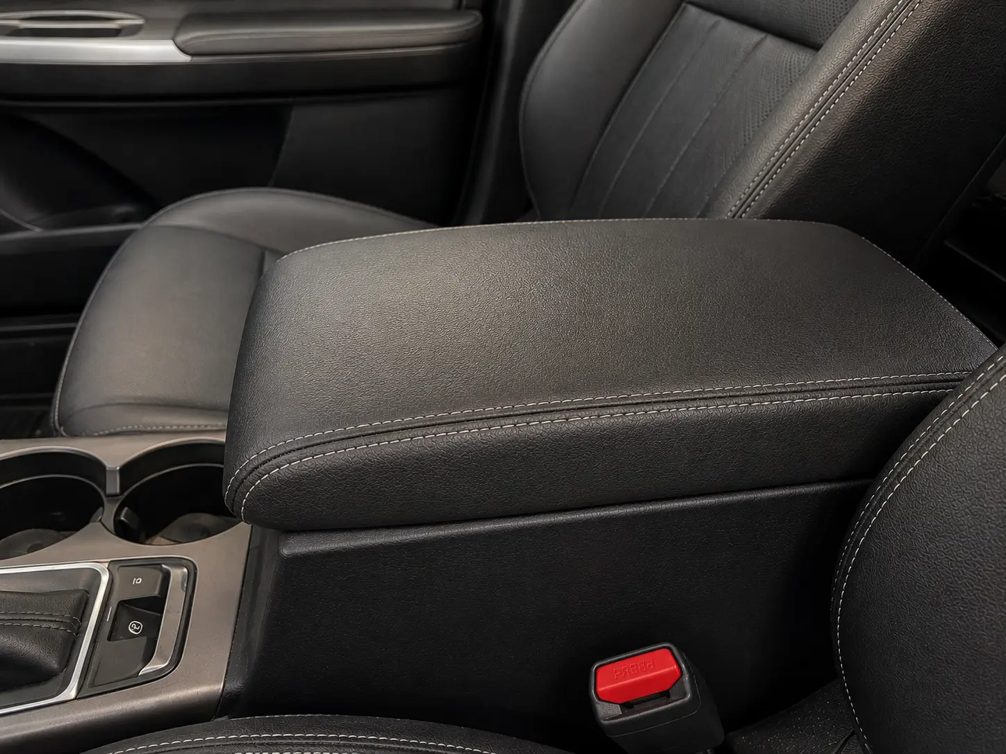 After vehicle center armrest upholstery repair